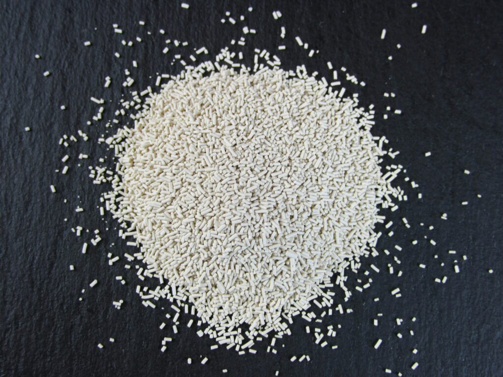 a pile of white rice sitting on top of a black surface